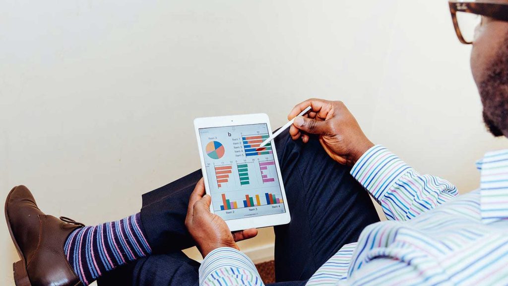 Man looking at tablet reports